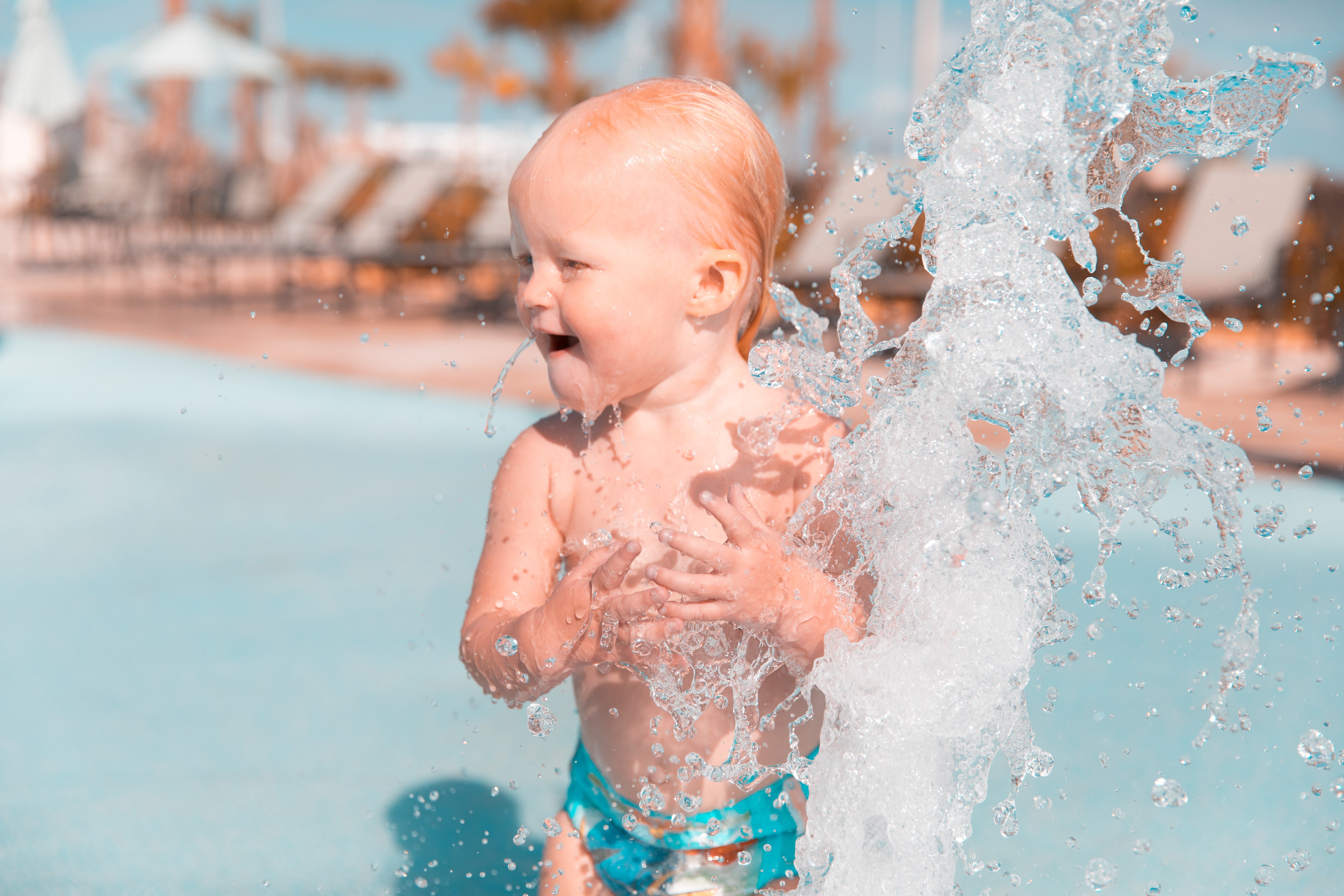 Young child playing in outdoor pool in Calgary